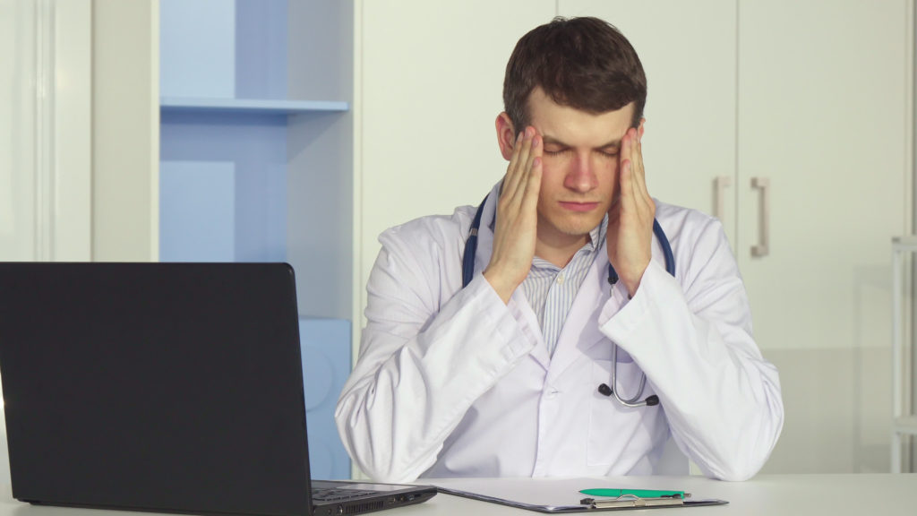 frustrated doctor on computer frustrated doctor on computer